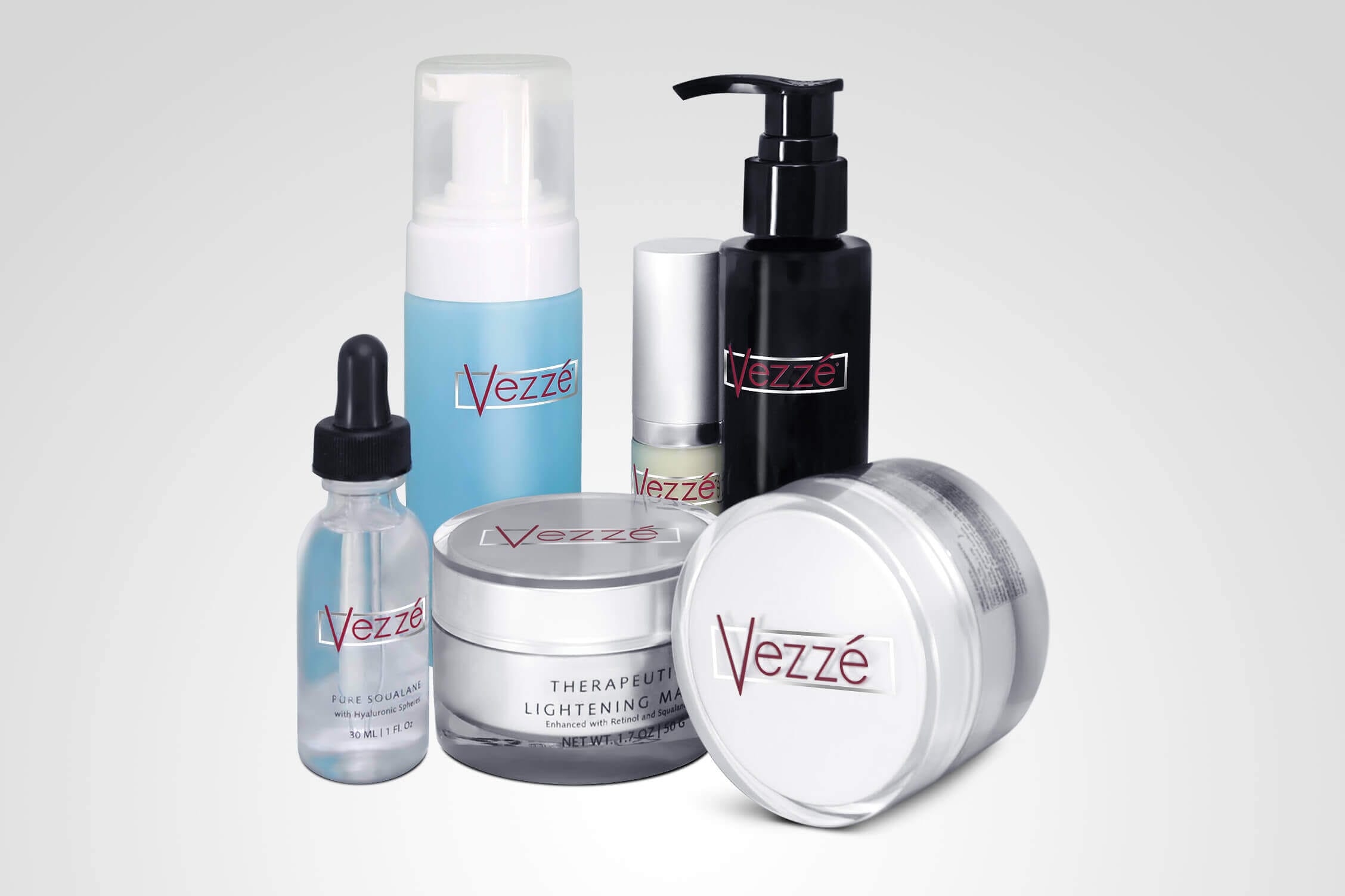 Skincare products assortment with Vezzé branding, including serums, creams, and lotions on a white background.