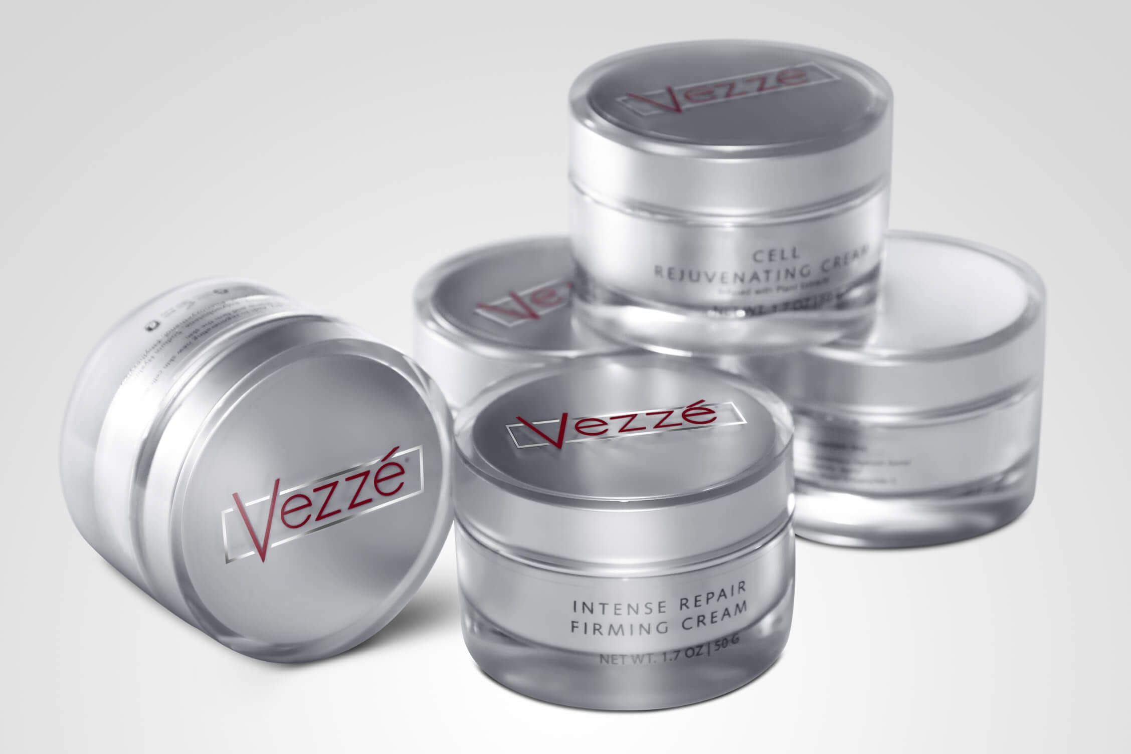 Vezze skincare cream jars, including intense repair and cell rejuvenating creams, with sleek silver packaging.